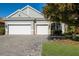 Two-car garage, paver driveway & landscaped lawn at 629 Wildlife Gln, Bradenton, FL 34209