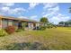 The backyard includes a lawn, various bushes, and a porch at 6314 29Th W Ave, Bradenton, FL 34209