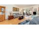 Cozy living room with wood flooring, comfortable couches, and a sliding glass door to a screened-in porch at 6314 29Th W Ave, Bradenton, FL 34209