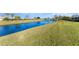 Picturesque waterfront view with a lush green lawn leading to a tranquil pond at 6314 29Th W Ave, Bradenton, FL 34209