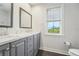 Modern bathroom with gray double vanity and a window at 6330 Laguna Dr, Longboat Key, FL 34228