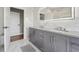 Elegant bathroom with gray double vanity and marble tile at 6330 Laguna Dr, Longboat Key, FL 34228