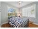 Bedroom with a striped comforter and two windows at 6330 Laguna Dr, Longboat Key, FL 34228