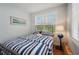 Small bedroom with striped bedding and window at 6330 Laguna Dr, Longboat Key, FL 34228