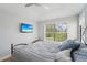 Bedroom with a bed, large window, and wall-mounted TV at 6330 Laguna Dr, Longboat Key, FL 34228