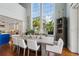 Elegant dining room with large windows, a long table, and hardwood floors at 6330 Laguna Dr, Longboat Key, FL 34228