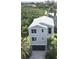 Two-story home with gray siding, a metal roof, and a two-car garage at 6330 Laguna Dr, Longboat Key, FL 34228