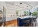 Modern kitchen featuring white cabinets, blue island, and high-end appliances at 6330 Laguna Dr, Longboat Key, FL 34228