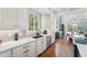 White kitchen with subway tile backsplash and stainless steel appliances at 6330 Laguna Dr, Longboat Key, FL 34228