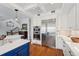 Modern kitchen boasts stainless steel appliances and white cabinetry at 6330 Laguna Dr, Longboat Key, FL 34228