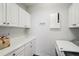 Bright laundry room with washer, dryer and counter space at 6330 Laguna Dr, Longboat Key, FL 34228