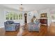 Spacious living area with hardwood floors, comfortable seating, and a view of the staircase at 6330 Laguna Dr, Longboat Key, FL 34228