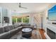 Open living area with sectional sofa, hardwood floors, and access to a balcony at 6330 Laguna Dr, Longboat Key, FL 34228