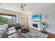 Spacious living room featuring a comfortable sectional sofa and a modern fireplace at 6330 Laguna Dr, Longboat Key, FL 34228