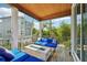 Screened porch features fire pit and comfy seating at 6330 Laguna Dr, Longboat Key, FL 34228