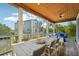 Relaxing screened porch with dining area and seating at 6330 Laguna Dr, Longboat Key, FL 34228