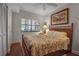 Cozy bedroom with a wooden bed frame and window blinds at 6430 Sun Eagle Ln # 201, Bradenton, FL 34210