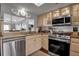 Modern kitchen with stainless steel appliances and granite countertops at 6430 Sun Eagle Ln # 201, Bradenton, FL 34210