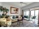 Spacious living room with hardwood floors, comfortable seating and water views at 6430 Sun Eagle Ln # 201, Bradenton, FL 34210