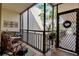 Relaxing screened balcony with seating and plants at 6430 Sun Eagle Ln # 201, Bradenton, FL 34210