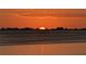 Stunning sunset over calm water with tree line at 6430 Sun Eagle Ln # 201, Bradenton, FL 34210