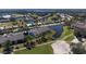 Aerial view of condos, lake, and golf course surrounded by a beautiful scenery at 6609 Stone River Rd # 206, Bradenton, FL 34203