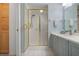 Well-appointed bathroom featuring a modern vanity and a glass-enclosed shower with gold trim at 6609 Stone River Rd # 206, Bradenton, FL 34203
