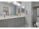 Elegant bathroom with double vanity, bright lighting, and a large mirror offering a serene atmosphere at 6609 Stone River Rd # 206, Bradenton, FL 34203