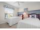 Comfortable bedroom with twin beds, coastal décor, and natural light creating a peaceful retreat at 6609 Stone River Rd # 206, Bradenton, FL 34203