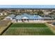 An aerial showcases the clubhouse adjacent to the putting green, tennis court, and parking, enhancing community lifestyle at 6609 Stone River Rd # 206, Bradenton, FL 34203