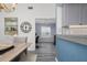 Open dining area with a rustic table, view of a home office, and kitchen elements at 6609 Stone River Rd # 206, Bradenton, FL 34203