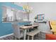 Bright dining room with a chandelier, a rustic table with a bench, and a view of the modern kitchen at 6609 Stone River Rd # 206, Bradenton, FL 34203