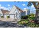 Exterior shot of townhomes showcasing attached garages, landscaping, and neutral color palette at 6609 Stone River Rd # 206, Bradenton, FL 34203