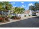 Exterior view with well-maintained landscaping and view of the garages at 6609 Stone River Rd # 206, Bradenton, FL 34203