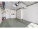 Spacious garage with ample storage cabinets, white door and peg board at 6609 Stone River Rd # 206, Bradenton, FL 34203