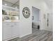 Hallway with a mirrored bar area, modern decorations, and access to an outdoor seating area at 6609 Stone River Rd # 206, Bradenton, FL 34203