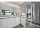 Updated kitchen with stainless steel refrigerator and a view to the open-concept living areas at 6609 Stone River Rd # 206, Bradenton, FL 34203