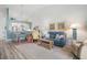 Cozy living room with coastal decor and a peek into the dining area with a rustic table at 6609 Stone River Rd # 206, Bradenton, FL 34203