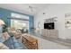 Bright living room with sliding glass doors to the porch, a TV, and beachy decor at 6609 Stone River Rd # 206, Bradenton, FL 34203