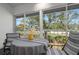 Enclosed patio with seating area overlooking a lush green landscape and trees at 6609 Stone River Rd # 206, Bradenton, FL 34203