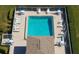 Top view of the community pool with chairs, tables and a pool house at 6609 Stone River Rd # 206, Bradenton, FL 34203