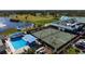 An aerial view of tennis courts and a pool, showcasing the recreational amenities available in the community at 6609 Stone River Rd # 206, Bradenton, FL 34203