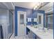 Bathroom with a white vanity, blue walls and shower at 6615 13Th E Ave, Bradenton, FL 34208