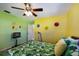 Bedroom with leafy bedding, ceiling fan and TV at 6615 13Th E Ave, Bradenton, FL 34208