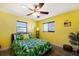 Bedroom with leafy bedding, ceiling fan and window at 6615 13Th E Ave, Bradenton, FL 34208