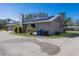 Home features solar panels, spacious driveway, and mature landscaping at 6615 13Th E Ave, Bradenton, FL 34208