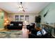 Comfortable living room boasts leather furniture and a ceiling fan at 6615 13Th E Ave, Bradenton, FL 34208