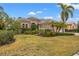 Single Gathering home with manicured lawn and palm trees at 7033 Brier Creek Ct, Lakewood Ranch, FL 34202