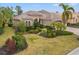 Luxury home with tile roof, manicured landscaping, and palm trees at 7033 Brier Creek Ct, Lakewood Ranch, FL 34202