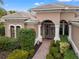 Inviting home exterior featuring a brick walkway and lush landscaping at 7033 Brier Creek Ct, Lakewood Ranch, FL 34202